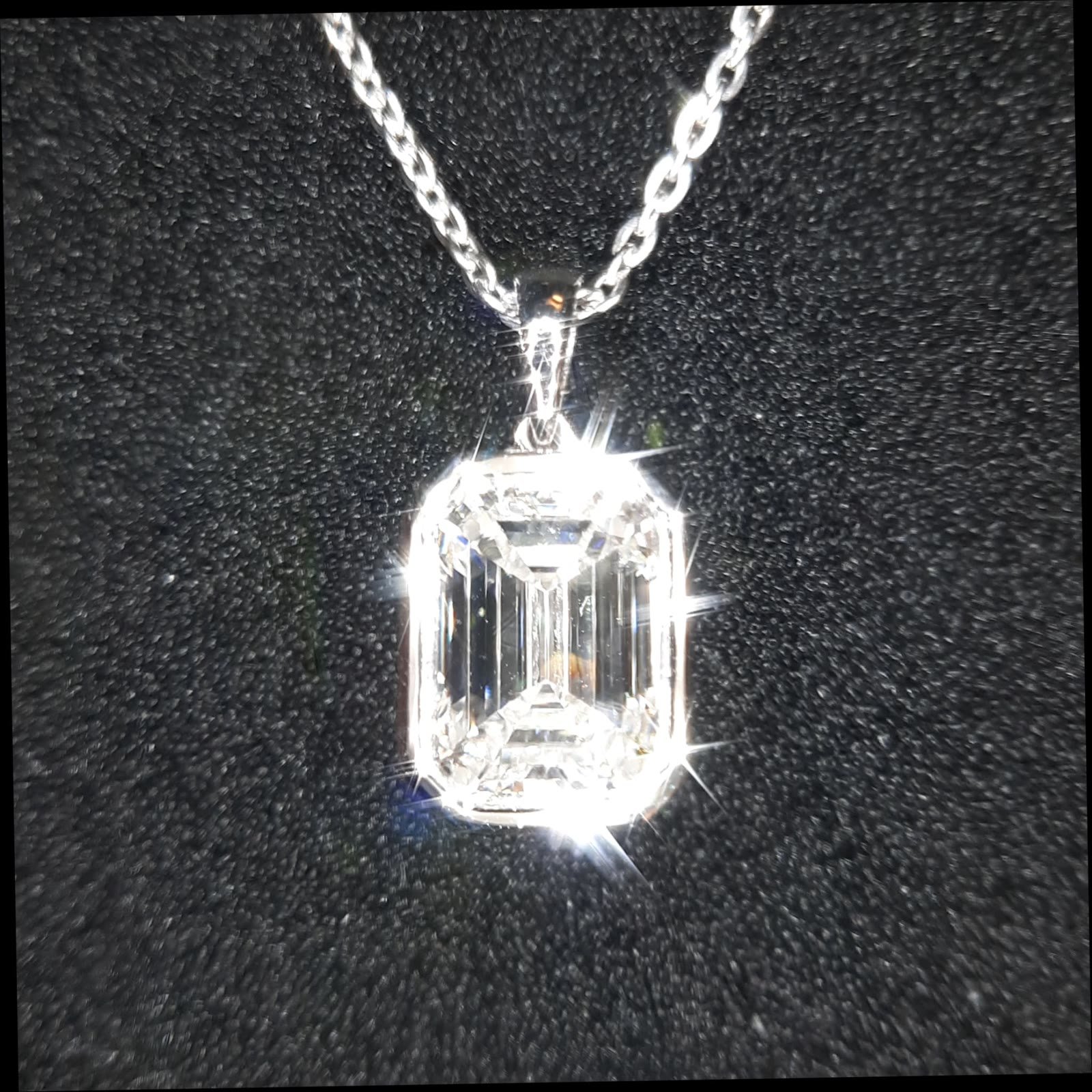 Four-carat emerald-cut lab-grown diamond pendant with platinum setting, JM LUCENT fine jewellery.